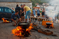 People cooking fish stew during summer fest Tunuara in place Kali, island Ugljan, Dalmatia, Croatia