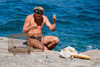 Man repairing fish trap net, island Korcula, Croatia